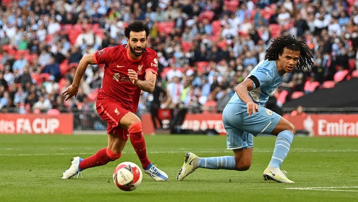 LONDON, ENGLAND - APRIL 16: Mohamed Salah of Liverpool is tackled by Nathan Ake of Manchester City during The Emirates FA Cup Semi-Final match between Manchester City and Liverpool at Wembley Stadium on April 16, 2022 in London, England. (Photo by Shaun Botterill/Getty Images)