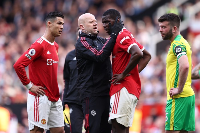 MANCHESTER, ENGLAND - APRIL 16: Paul Pogba of Manchester United receives medical treatment during the Premier League match between Manchester United and Norwich City at Old Trafford on April 16, 2022 in Manchester, England. (Photo by Naomi Baker/Getty Images)