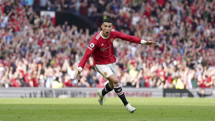 Manchester Uniteds Cristiano Ronaldo celebrates after scoring his third goal during the English Premier League soccer match between Manchester United and Norwich City at Old Trafford stadium in Manchester, England, Saturday, April 16, 2022. (AP Photo/Jon Super)