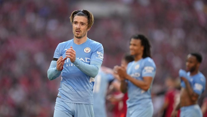 Manchester Citys Jack Grealish applauds the fans at the end of the English FA Cup semifinal soccer match between Manchester City and Liverpool at Wembley stadium in London, Saturday, April 16, 2022. Liverpool won 3-2. (AP Photo/Kirsty Wigglesworth)