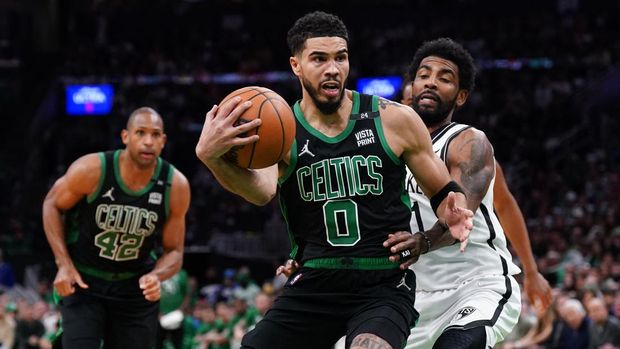 Apr 17, 2022; Boston, Massachusetts, USA; Boston Celtics forward Jayson Tatum (0) drives the ball against Brooklyn Nets guard Kyrie Irving (11) in the second half during game one of the first round for the 2022 NBA playoffs at TD Garden. Mandatory Credit: David Butler II-USA TODAY Sports