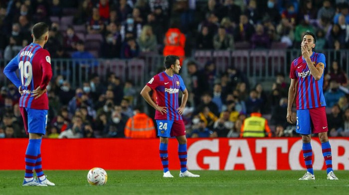 Barcelona players react after Cadiz scored their opening goal during a Spanish La Liga soccer match between FC Barcelona and Cadiz at the Camp Nou stadium in Barcelona, Spain, Monday, April 18, 2022. (AP Photo/Joan Monfort)