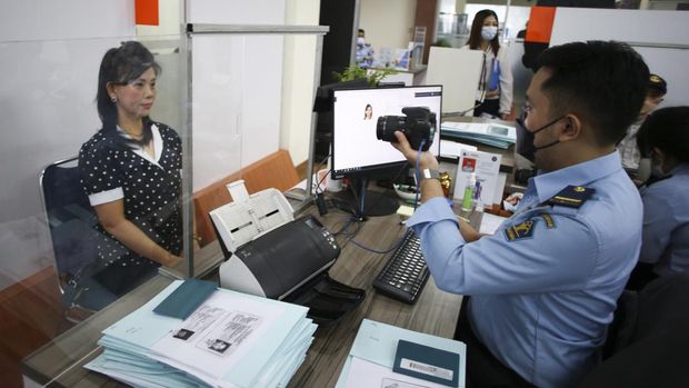 Petugas melayani pemohon paspor di Kantor Imigrasi Jakarta Barat, Senin (18/4/2022). Direktorat Jenderal (Ditjen) Imigrasi Kementerian Hukum dan HAM menyatakan jumlah permohonan paspor pada periode 1 Januari sampai 11 April 2022 mengalami peningkatan sebanyak 522.316 pemohon atau meningkat 41 persen jika dibandingkan dengan kuartal keempat tahun 2021 yaitu sebanyak 369.288. ANTARA FOTO/Rivan Awal Lingga/aww.