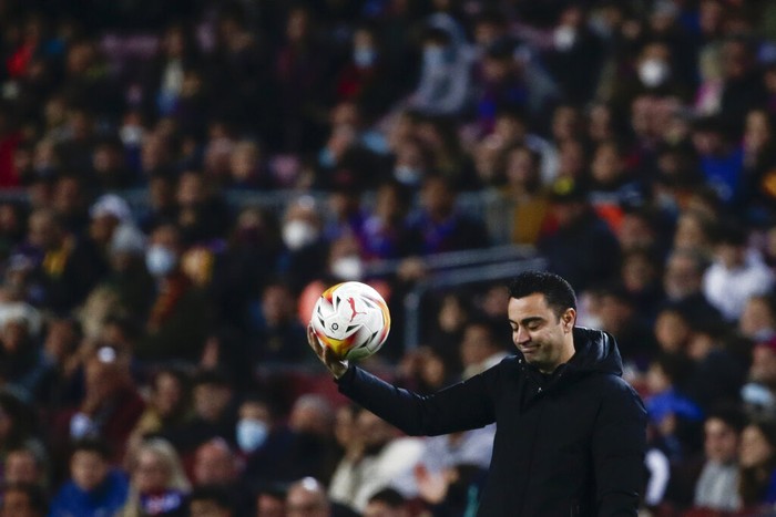 Barcelonas head coach Xavi Hernandez holds a ball during a Spanish La Liga soccer match between FC Barcelona and Cadiz at the Camp Nou stadium in Barcelona, Spain, Monday, April 18, 2022. (AP Photo/Joan Monfort)