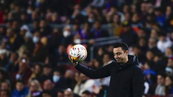 Barcelonas head coach Xavi Hernandez holds a ball during a Spanish La Liga soccer match between FC Barcelona and Cadiz at the Camp Nou stadium in Barcelona, Spain, Monday, April 18, 2022. (AP Photo/Joan Monfort)