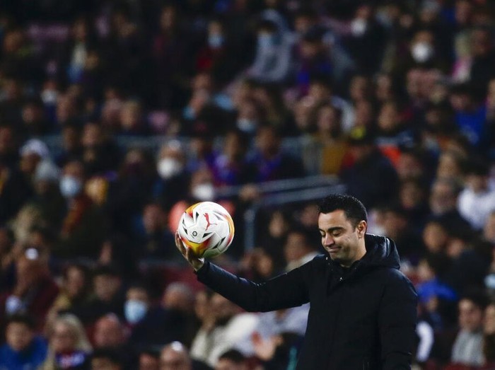 Barcelona's head coach Xavi Hernandez holds a ball during a Spanish La Liga soccer match between FC Barcelona and Cadiz at the Camp Nou stadium in Barcelona, Spain, Monday, April 18, 2022. (AP Photo/Joan Monfort)