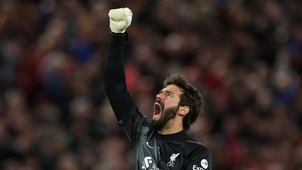 Soccer Football - Premier League - Liverpool v Manchester United - Anfield, Liverpool, Britain - April 19, 2022 Liverpool's Alisson celebrates after Mohamed Salah scored their second goal REUTERS/Phil Noble EDITORIAL USE ONLY. No use with unauthorized audio, video, data, fixture lists, club/league logos or 'live' services. Online in-match use limited to 75 images, no video emulation. No use in betting, games or single club /league/player publications.  Please contact your account representative for further details.