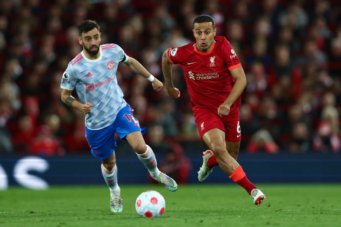 LIVERPOOL, ENGLAND - APRIL 19: Bruno Fernandes of Manchester United looks on as Thiago Alcantara of Liverpool runs with the ball during the Premier League match between Liverpool and Manchester United at Anfield on April 19, 2022 in Liverpool, England. (Photo by Clive Brunskill/Getty Images)