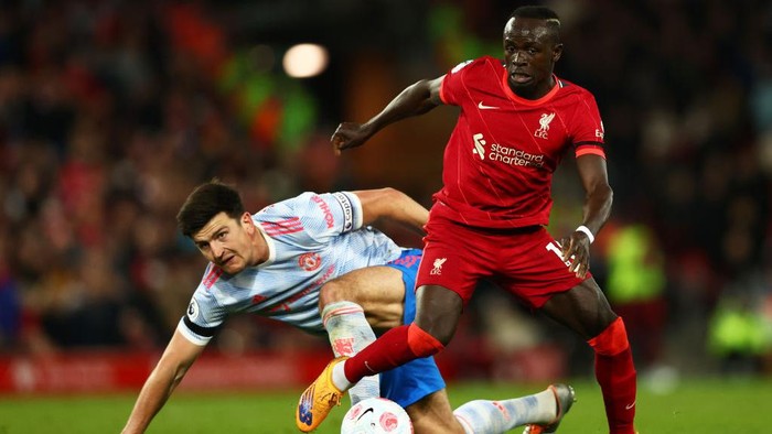 LIVERPOOL, ENGLAND - APRIL 19: Harry Maguire of Manchester United looks on as Sadio Mane of Liverpool runs with the ball during the Premier League match between Liverpool and Manchester United at Anfield on April 19, 2022 in Liverpool, England. (Photo by Clive Brunskill/Getty Images)