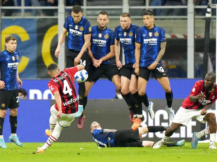 AC Milan's Theo Hernandez, left, and Inter Milan's Milan Skriniar vie for the ball during an Italian Cup semifinal, second leg, soccer match between Inter Milan and AC Milan, at the San Siro stadium, in Milan, Italy, Tuesday, April 19, 2022. (AP Photo/Luca Bruno)