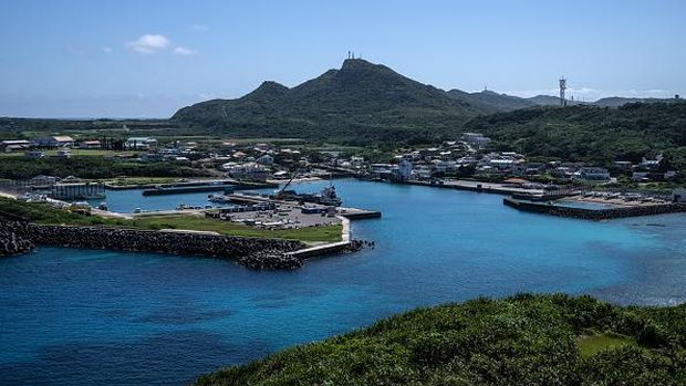 YONAGUNI, JAPAN - APRIL 13: A boy walks past houses on April 13, 2022 on Yonaguni, Japan. As Japans westernmost inhabited island, just 111 kilometres away from Taiwan and located close to the disputed Senkaku Islands, Yonaguni has seen an increased military presence as the Japanese government looks to ward off Chinese activity in nearby territory claimed by both countries. Japans Air Self-Defense Force has recently announced that it will permanently station a mobile radar unit on the island, adding to an existing military radar station which allows monitoring of the Chinese mainland and tracking of Chinese ships and aircraft in the area. Japans Ground Self-Defense Force also plans to deploy an electronic warfare unit to Yonaguni in 2023. (Photo by Carl Court/Getty Images)