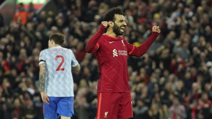 Liverpools Mohamed Salah celebrates after scoring his sides fourth goal during the English Premier League soccer match between Liverpool and Manchester United at Anfield stadium in Liverpool, England, Tuesday, April 19, 2022. (AP Photo/Jon Super)