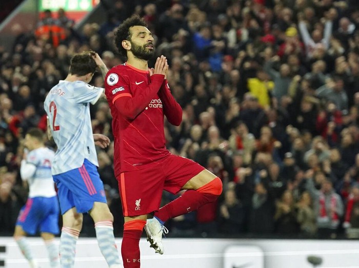 Liverpool's Mohamed Salah celebrates after scoring his side's fourth goal during the English Premier League soccer match between Liverpool and Manchester United at Anfield stadium in Liverpool, England, Tuesday, April 19, 2022. (AP Photo/Jon Super)