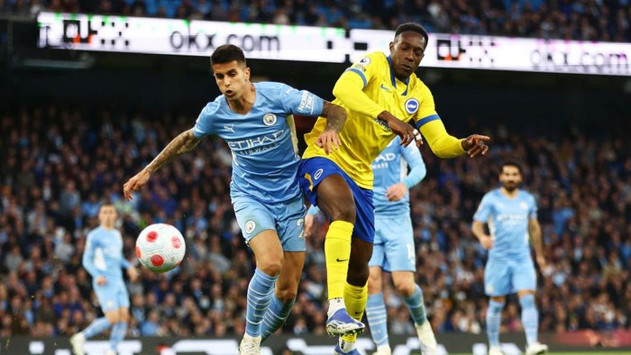 MANCHESTER, ENGLAND - APRIL 20: Joao Cancelo of Manchester City battles for possession with Danny Welbeck of Brighton & Hove Albion during the Premier League match between Manchester City and Brighton & Hove Albion at Etihad Stadium on April 20, 2022 in Manchester, England. (Photo by Clive Brunskill/Getty Images)