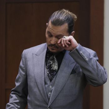 Actor Johnny Depp wipes an eye during his testimony at the defamation trial against his ex-wife Amber Heard, at the Fairfax County Circuit Courthouse in Fairfax, Virginia,  April 20, 2022. - Depp is suing ex-wife Heard for libel after she wrote an op-ed piece in The Washington Post in 2018 referring to herself as a public figure representing domestic abuse. (Photo by EVELYN HOCKSTEIN / POOL / AFP)