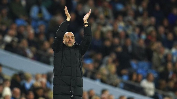 Manchester Citys head coach Pep Guardiola gestures during the English Premier League soccer match between Manchester City and Brighton and Hove Albion at the Etihad Stadium in Manchester, England, Wednesday, April 20, 2022. (AP Photo/Dave Thompson)