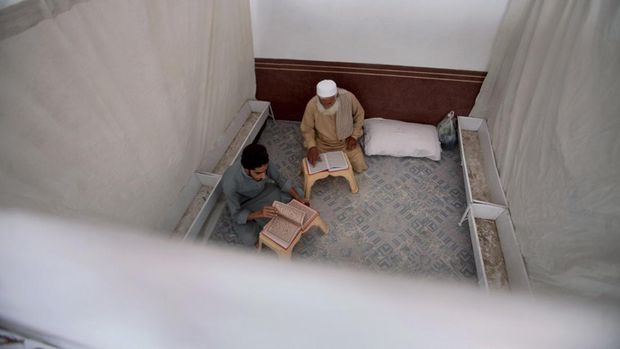 Muslim worshippers recite from the Quran in their section while they observes 