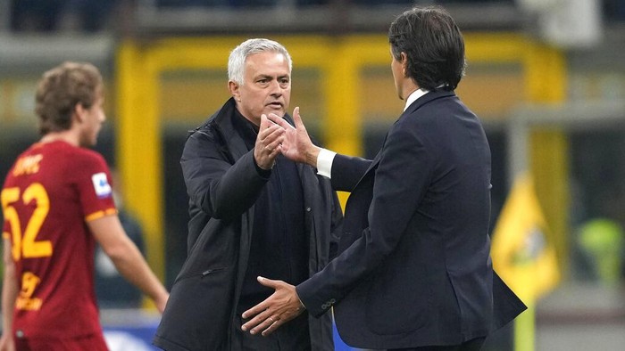 Inter Milans head coach Simone Inzaghi, right, and Romas head coach Jose Mourinho after the Serie A soccer match between Inter Milan and Roma at the San Siro Stadium, in Milan, Italy, Saturday, April 23, 2022. (AP Photo/Antonio Calanni)