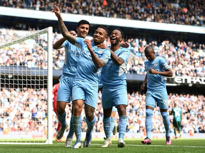 MANCHESTER, ENGLAND - APRIL 23: Gabriel Jesus celebrates with teammates Rodrigo and Raheem Sterling of Manchester City after scoring their sides fourth goal from a penalty during the Premier League match between Manchester City and Watford at Etihad Stadium on April 23, 2022 in Manchester, England. (Photo by Gareth Copley/Getty Images,)