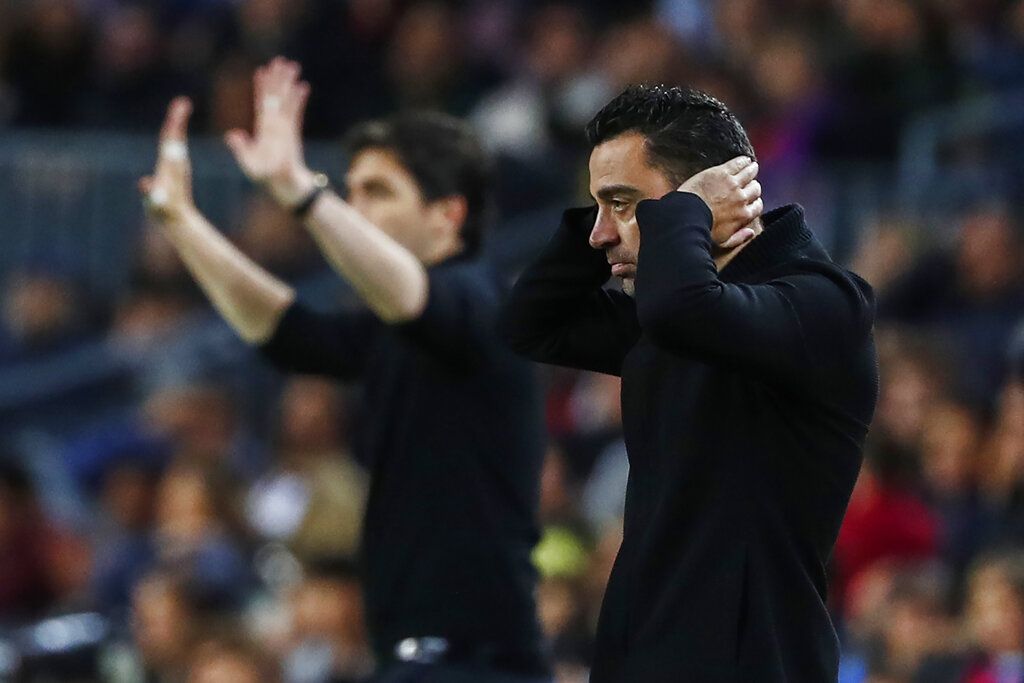 Barcelona's head coach Xavi Hernandez, right, reacts after the Spanish La Liga soccer match between FC Barcelona and Rayo Vallecano at the Camp Nou stadium in Barcelona, Spain, Sunday, April 24, 2022. (AP Photo/Joan Monfort)