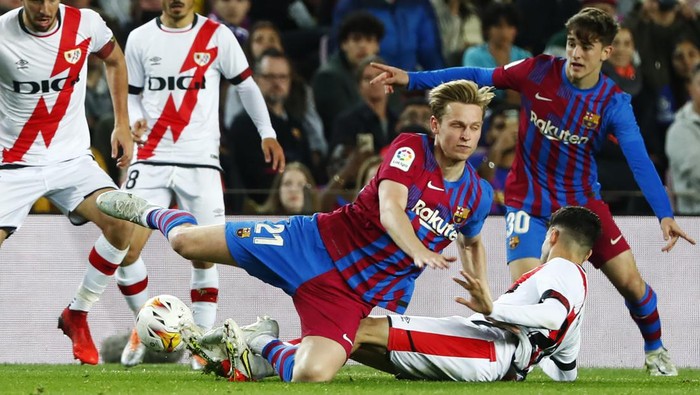 Barcelonas Frenkie de Jong, centre, and Rayos Nikola Maras, centre right, challenge for the ball during a Spanish La Liga soccer match between FC Barcelona and Rayo Vallecano at the Camp Nou stadium in Barcelona, Spain, Sunday, April 24, 2022. (AP Photo/Joan Monfort)