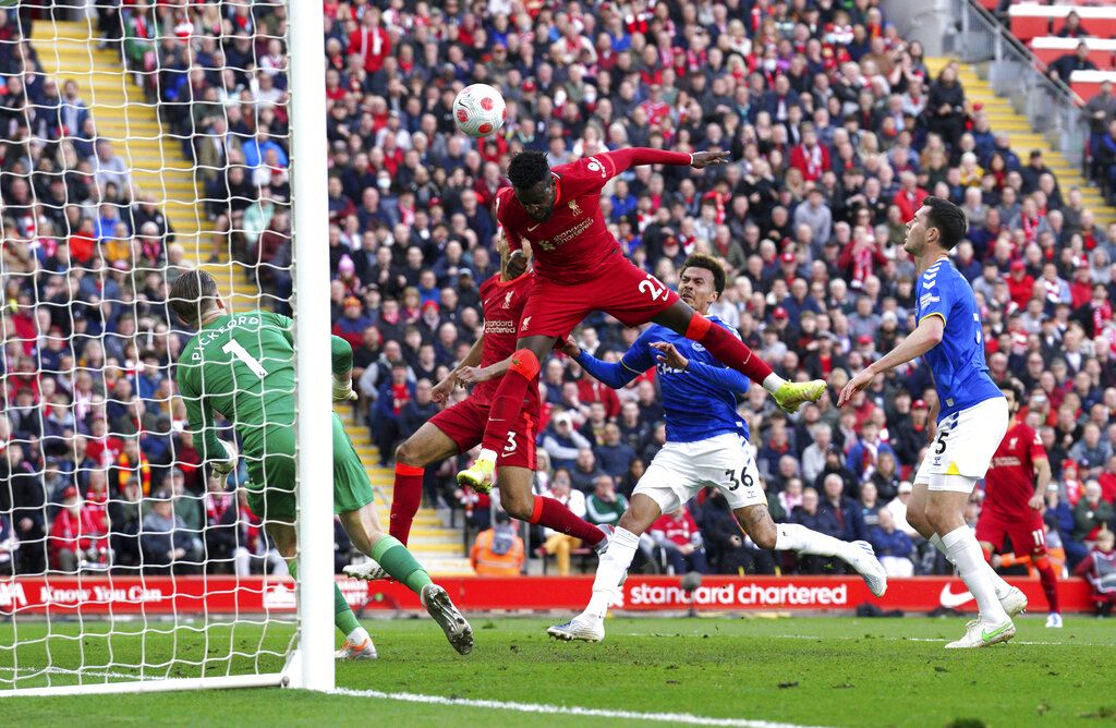 Liverpool's Divock Origi, center, scores his sides second goal during the English Premier League soccer match between Liverpool and Everton at Anfield stadium in Liverpool, England, Sunday, April 24, 2022. (Peter Byrne/PA via AP)