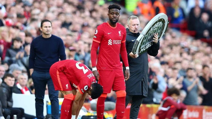 LIVERPOOL, ENGLAND - APRIL 24: Luis Diaz and Divock Origi of Liverpool are substituted on during the Premier League match between Liverpool and Everton at Anfield on April 24, 2022 in Liverpool, England. (Photo by Clive Brunskill/Getty Images)