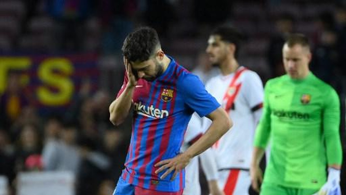 Jordi Alba tertunduk lesu usai Barcelona kalah dari Rayo Vallecano. Foto: AFP/LLUIS GENE