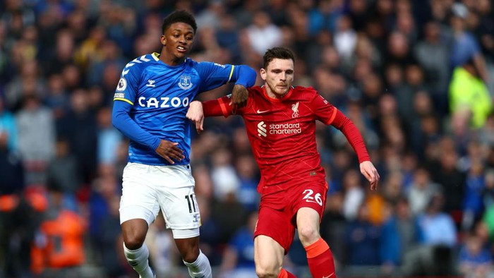 LIVERPOOL, ENGLAND - APRIL 24: Andrew Robertson of Liverpool is challenged by Demarai Gray of Everton during the Premier League match between Liverpool and Everton at Anfield on April 24, 2022 in Liverpool, England. (Photo by Clive Brunskill/Getty Images)