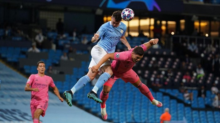 MANCHESTER, ENGLAND - AUGUST 07: Aymeric Laporte of Manchester City competes for a header with Luka Jovic of Real Madrid during the UEFA Champions League round of 16 second leg match between Manchester City and Real Madrid at Etihad Stadium on August 07, 2020 in Manchester, England. (Photo by Dave Thompson/Pool via Getty Images)