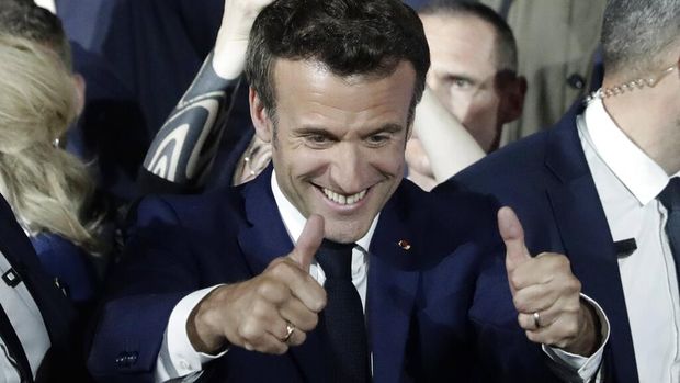 French President Emmanuel Macron and French first lady Brigitte Macron celebrate with supporters in Paris, France, Sunday, April 24, 2022. Polling agencies projected that French President Emmanuel Macron comfortably won reelection Sunday in the presidential runoff, offering French voters and the European Union the reassurance of leadership stability in the bloc's only nuclear-armed power as the continent grapples with Russia's invasion of Ukraine.