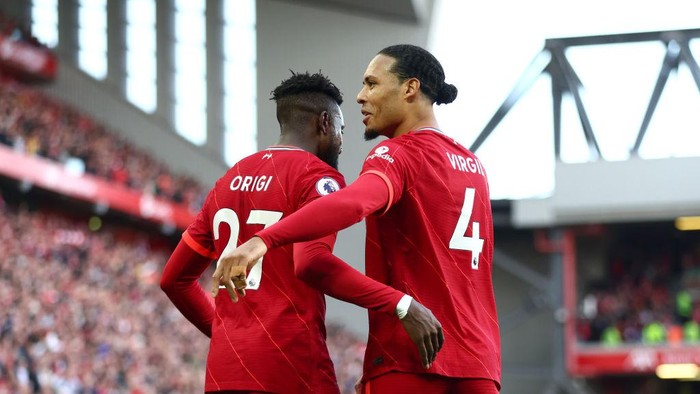 LIVERPOOL, ENGLAND - APRIL 24: Divock Origi celebrates with Virgil van Dijk of Liverpool after scoring their teams second goal during the Premier League match between Liverpool and Everton at Anfield on April 24, 2022 in Liverpool, England. (Photo by Clive Brunskill/Getty Images)