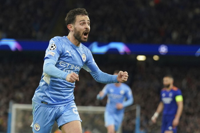 Manchester Citys Bernardo Silva celebrates after scoring his sides fourth goal during the Champions League semi final, first leg soccer match between Manchester City and Real Madrid at the Etihad stadium in Manchester, England, Tuesday, April 26, 2022. (AP Photo/Jon Super)