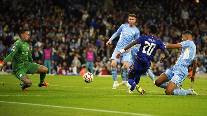 Real Madrids Karim Benzema, right, celebrates after scoring his sides opening goal during the Champions League semi final, first leg soccer match between Manchester City and Real Madrid at the Etihad stadium in Manchester, England, Tuesday, April 26, 2022. (AP Photo/Jon Super)