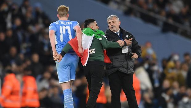 MANCHESTER, ENGLAND - APRIL 26: A fan invades the pitch and interacts with Kevin De Bruyne of Manchester City during the UEFA Champions League Semi Final Leg One match between Manchester City and Real Madrid at Etihad Stadium on April 26, 2022 in Manchester, England. (Photo by David Ramos/Getty Images)