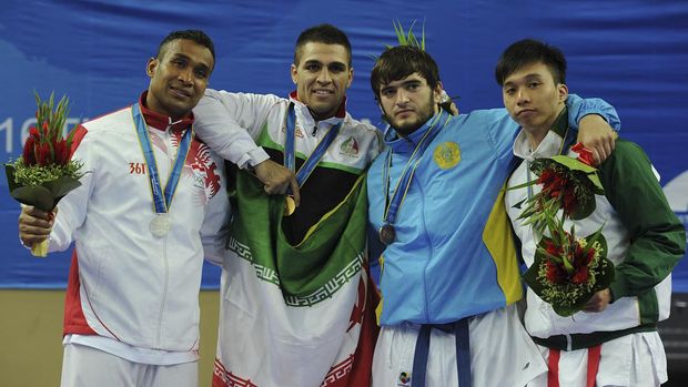 Medalists (from L-R), Umar Syarief of Indonesia  (silver), Z Poorshab of Iran (gold), K Khalidov of Kazakhstan (bronze) and KC Lei of Macau (bronze) stand for a group picture after the medal ceremony for the men's  +84KG karate at the 16th Asian Games in Guangzhou on November 24, 2010.    .       AFP PHOTO/MIKE CLARKE (Photo by MIKE CLARKE / AFP)