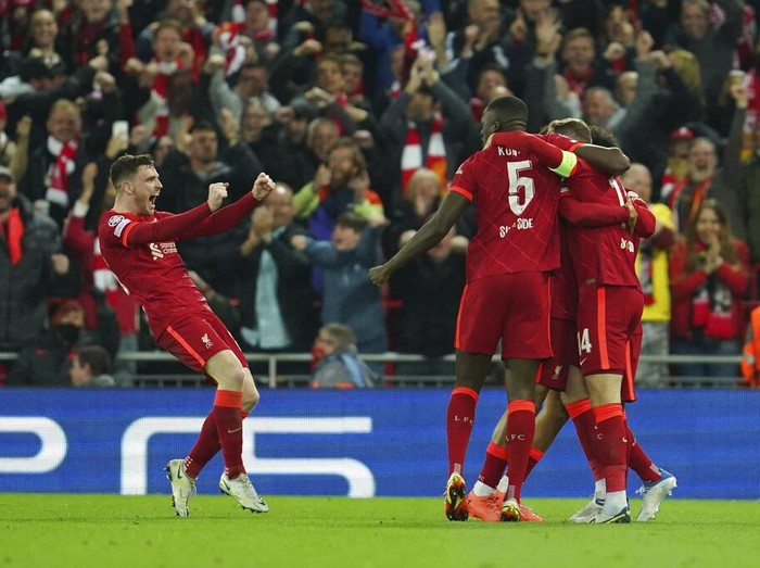 Liverpool players celebrate after Villarreal's Pervis Estupinan scored an own goal during the Champions League semi final, first leg soccer match between Liverpool and Villarreal at Anfield stadium in Liverpool, England, Wednesday, April 27, 2022. (AP Photo/Jon Super)