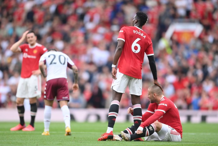 MANCHESTER, ENGLAND - SEPTEMBER 25: Paul Pogba of Manchester United with an injured Luke Shaw during the Premier League match between Manchester United and Aston Villa at Old Trafford on September 25, 2021 in Manchester, England. (Photo by Laurence Griffiths/Getty Images)