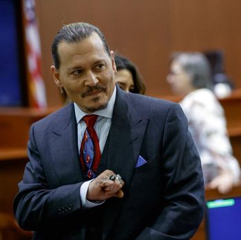 Actor Johnny Depp watches a pre-recorded deposition testimony of Christian Carino at the Fairfax County Circuit Court in Fairfax, Va., Wednesday, April 27, 2022. Depp sued his ex-wife actress Amber Heard for libel in Fairfax County Circuit Court after she wrote an op-ed piece in The Washington Post in 2018 referring to herself as a 