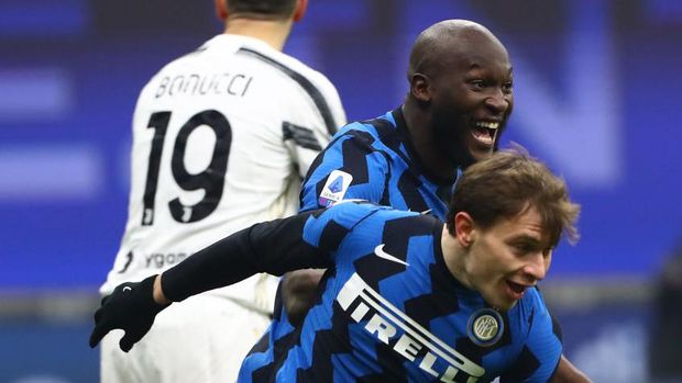 MILAN, ITALY - JANUARY 17:  Nicolo Barella of FC Internazionale celebrates his goal with his team-mate Romelu Lukaku (back) during the Serie A match between FC Internazionale and Juventus at Stadio Giuseppe Meazza on January 17, 2021 in Milan, Italy. Sporting stadiums around Italy remain under strict restrictions due to the Coronavirus Pandemic as Government social distancing laws prohibit fans inside venues resulting in games being played behind closed doors.  (Photo by Marco Luzzani/Getty Images)