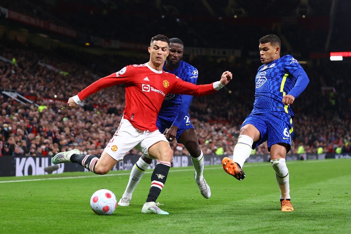 MANCHESTER, ENGLAND - APRIL 28: Cristiano Ronaldo of Manchester United celebrates victory Antonio Ruediger and Thiago Silva of Chelsea during the Premier League match between Manchester United and Chelsea at Old Trafford on April 28, 2022 in Manchester, England. (Photo by Michael Steele/Getty Images)