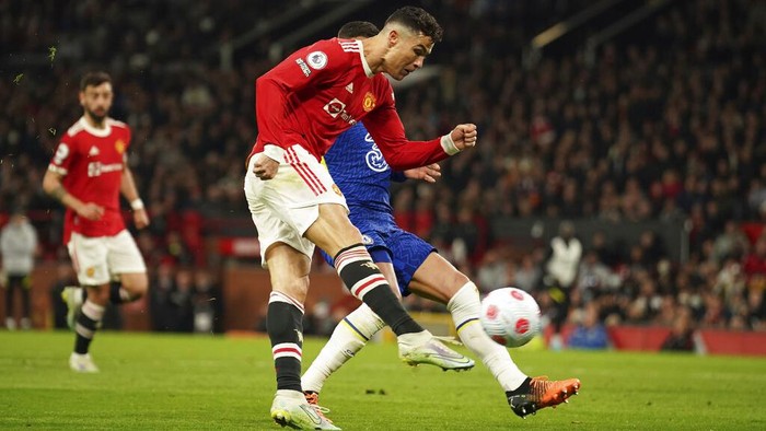 Manchester Uniteds Cristiano Ronaldo scores his sides first goal during the English Premier League soccer match between Manchester United and Chelsea, at Old Trafford Stadium, Manchester, England, Thursday, April, 2022. (AP Photo/Dave Thompson)