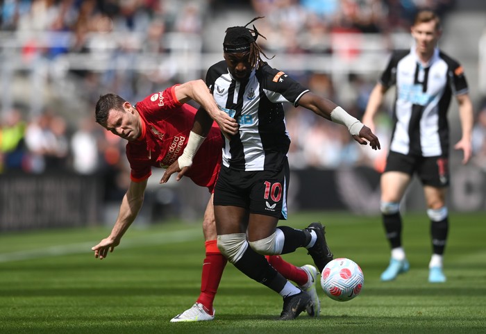 NEWCASTLE UPON TYNE, ENGLAND - APRIL 30: Allan Saint-Maximin of Newcastle United is challenged by James Milner of Liverpool during the Premier League match between Newcastle United and Liverpool at St. James Park on April 30, 2022 in Newcastle upon Tyne, England. (Photo by Stu Forster/Getty Images)