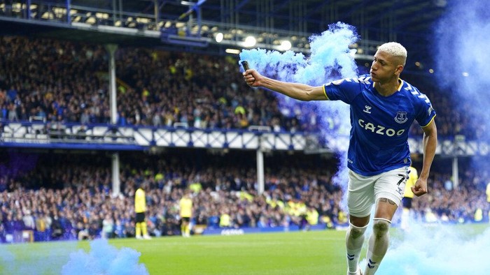 Evertons Richarlison ruins with a flare as he celebrates after scoring his sides first goal during the Premier League soccer match between Everton and Chelsea at Goodison Park in Liverpool, England, Sunday, May 1, 2022. (AP Photo/Jon Super)
