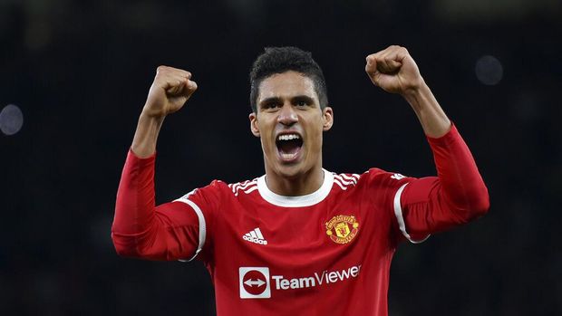 Manchester United's Raphael Varane celebrates at the end of the English Premier League soccer match between Manchester United and Tottenham Hotspur, at the Old Trafford stadium in Manchester, England, Saturday, March 12, 2022. (AP Photo/Rui Vieira)