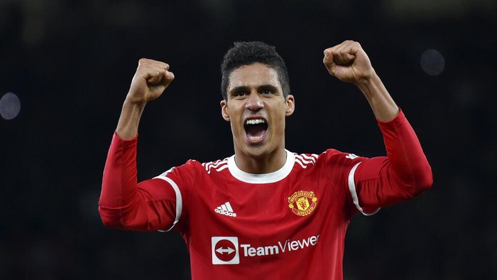 Manchester Uniteds Raphael Varane celebrates at the end of the English Premier League soccer match between Manchester United and Tottenham Hotspur, at the Old Trafford stadium in Manchester, England, Saturday, March 12, 2022. (AP Photo/Rui Vieira)