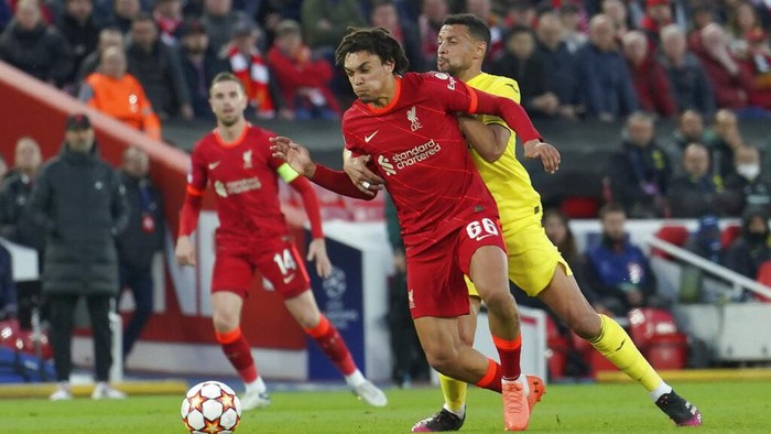 Liverpools Trent Alexander-Arnold, left, is challenged by Villarreals Francis Coquelin during the Champions League semi final, first leg soccer match between Liverpool and Villarreal at Anfield stadium in Liverpool, England, Wednesday, April 27, 2022. (AP Photo/Jon Super)
