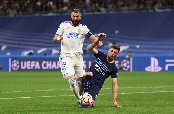 Karim Benzema vs Man City MADRID, SPAIN - MAY 04: Karim Benzema of Real Madrid is fouled by Ruben Dias of Manchester City leading to a penalty being awarded during the UEFA Champions League Semi Final Leg Two match between Real Madrid and Manchester City at Estadio Santiago Bernabeu on May 04, 2022 in Madrid, Spain. (Photo by Michael Regan/Getty Images)