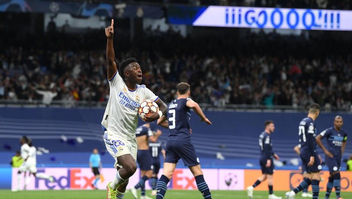MADRID, SPAIN - MAY 04: Vinicius Junior of Real Madrid celebrates after their sides second goal scored by Rodrygo of Real Madrid (not pictured) during the UEFA Champions League Semi Final Leg Two match between Real Madrid and Manchester City at Estadio Santiago Bernabeu on May 04, 2022 in Madrid, Spain. (Photo by David Ramos/Getty Images)