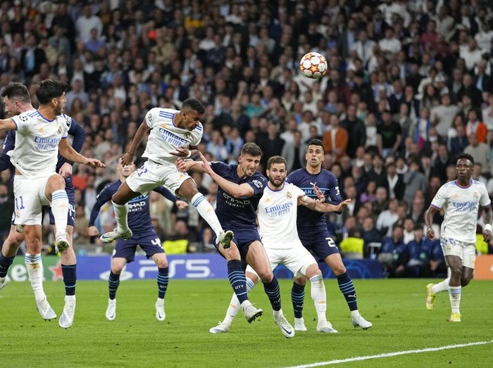 Real Madrid's Rodrygo, third left, scores his side's second goal during the Champions League semi final, second leg, soccer match between Real Madrid and Manchester City at the Santiago Bernabeu stadium in Madrid, Spain, Wednesday, May 4, 2022. (AP Photo/Bernat Armangue)